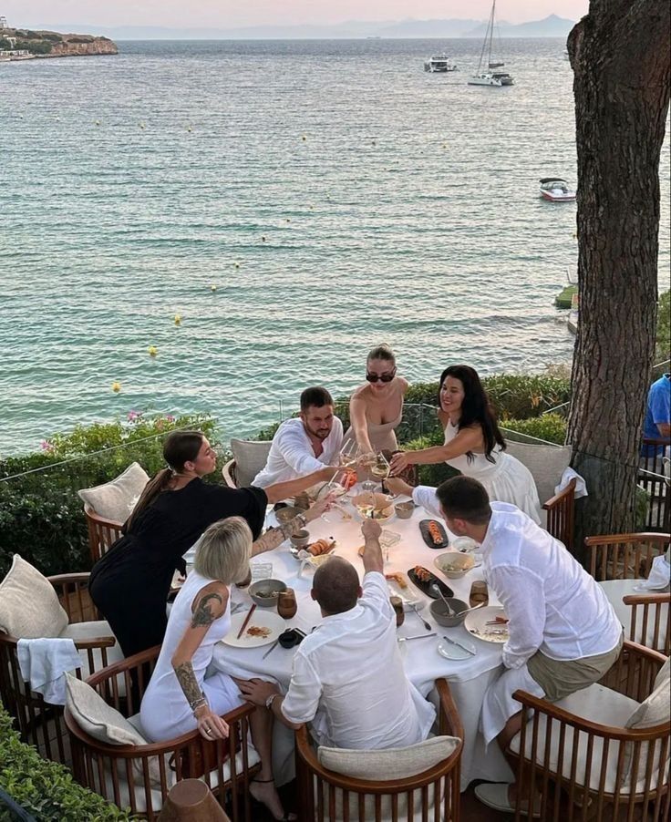 Friends gathered around a long dinner table